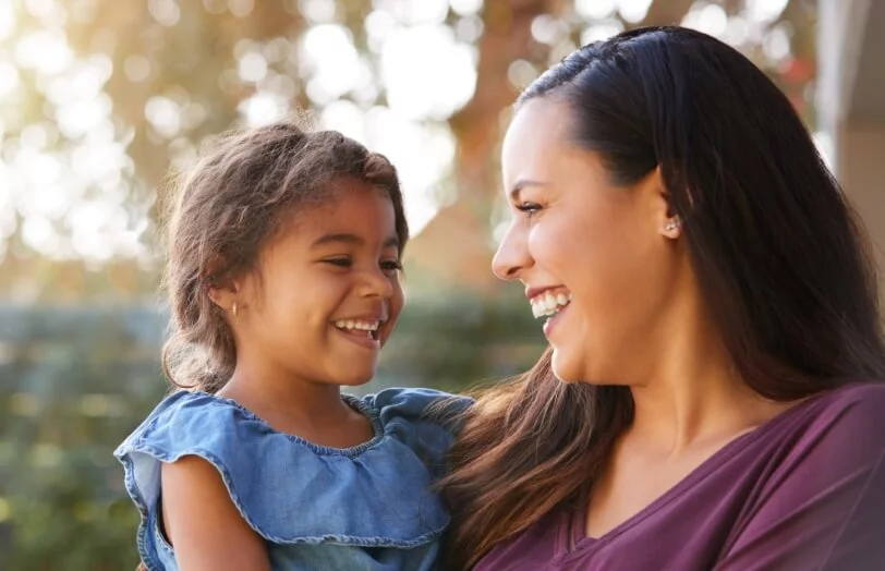 woman and her daughter smiling after visiting the dentist in Dallas, TX